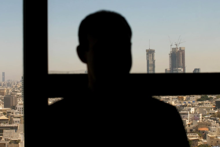 A silhouette looking out of a window
