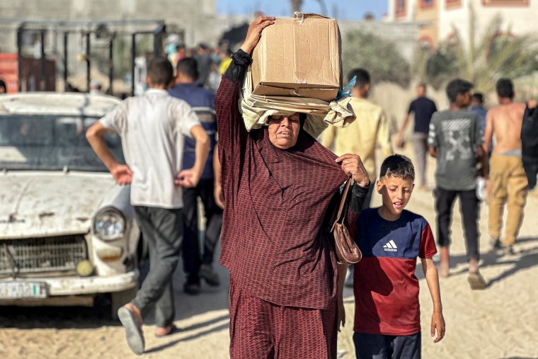 A woman carries a food package on her head