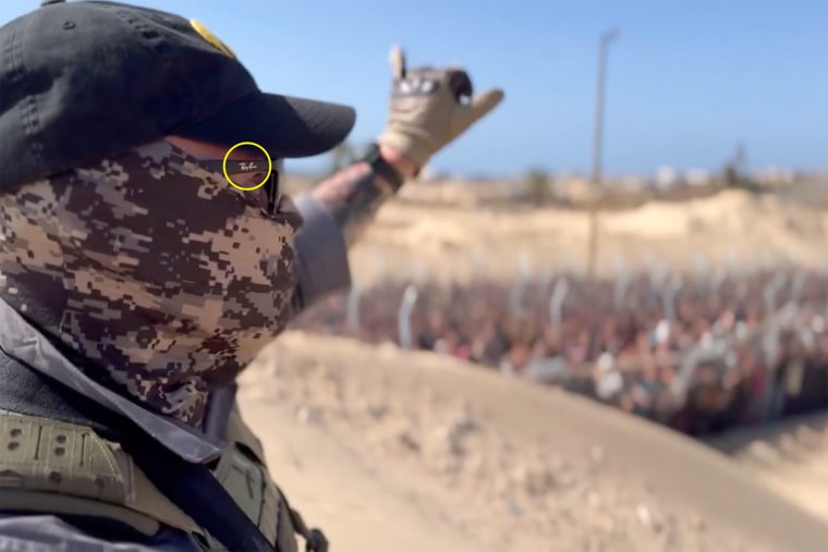 A crisp "Ray Ban" logo can be seen on the side of the sunglasses worn by a person seen in the video.