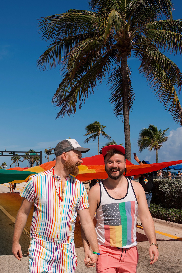 Daan Colijn and Karl Krause smiling and holding hands during Fort Lauderdale Pride