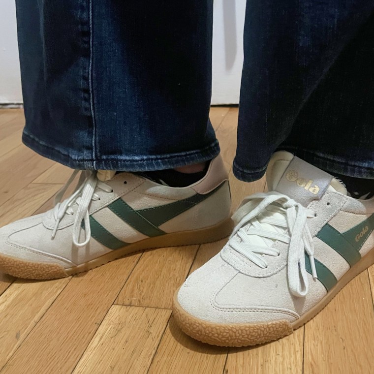 Woman wearing green Gola Elan sneakers and blue jeans