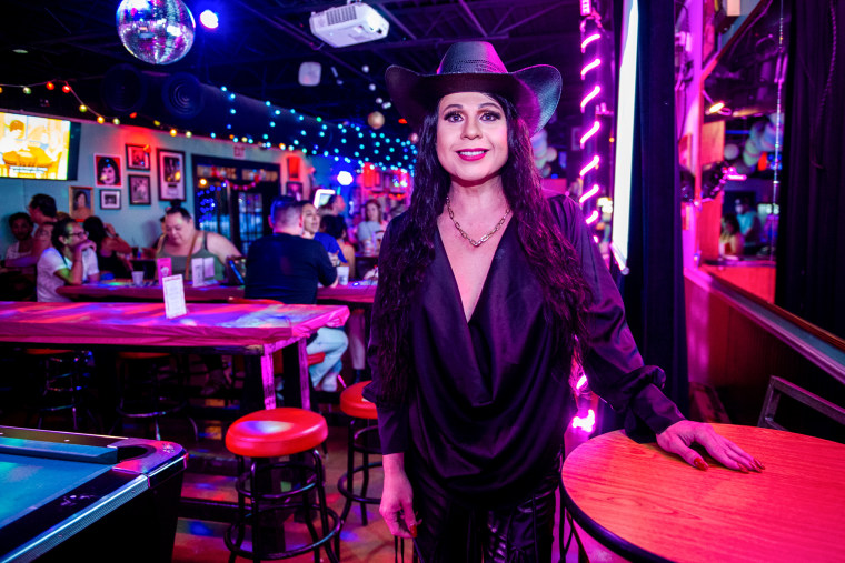 Audrey Campos smiles while standing inside of a club