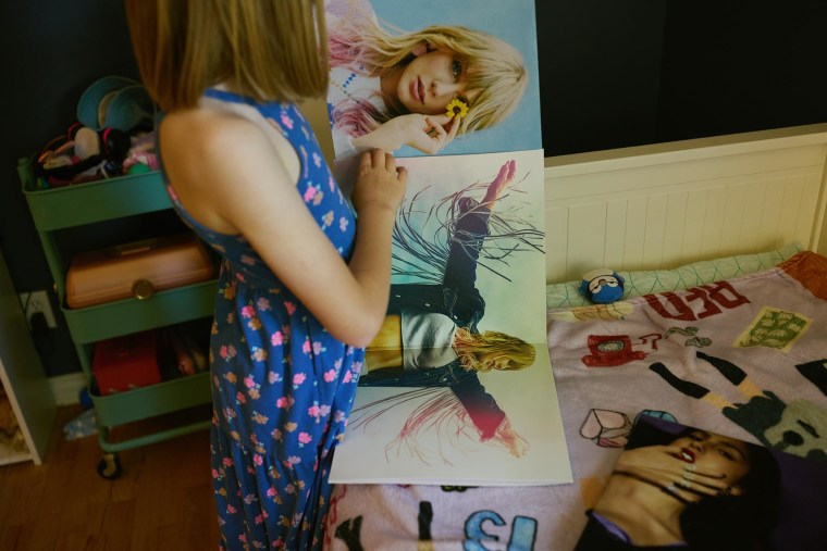 Chase looks at pictures of Taylor Swift in her bedroom.