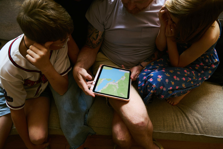 Chase's family looks at a map of Queenstown, New Zealand.