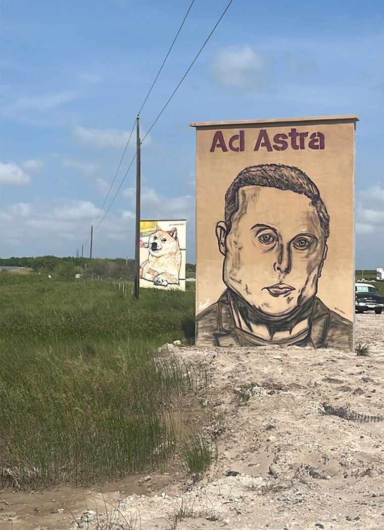 Hai bức tranh tường, một bức về Elon Musk và dòng chữ "Ad Astra", có nghĩa là "tới các vì sao", và bức còn lại về meme "Doge", nằm bên lề đại lộ Boca Chica, con đường chính hướng vào Starbase, Texas.