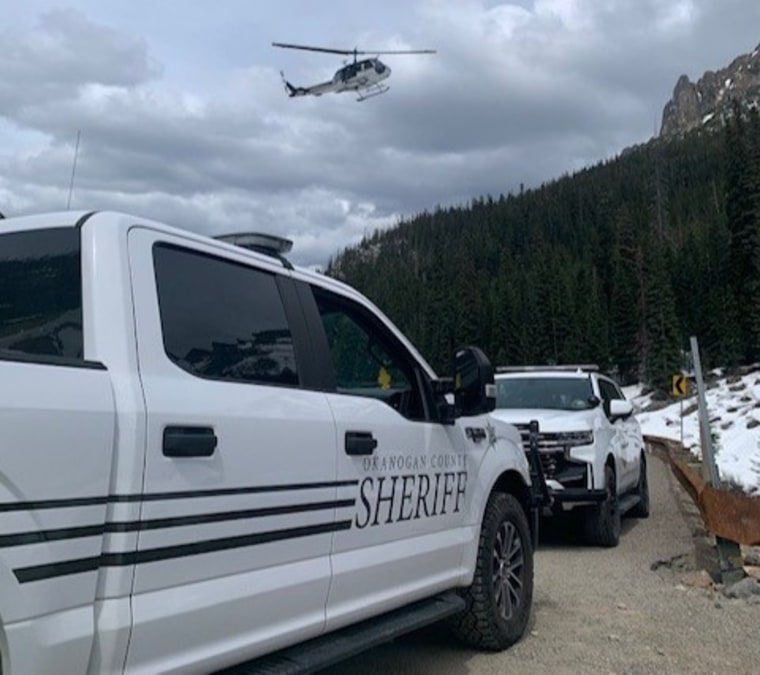 Okanogan County Sheriff’s Office personnel respond to the scene in the area of North Early Winters Spire, Washington on Sunday.