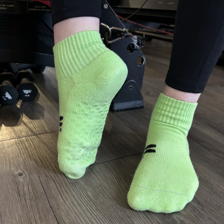 A woman wearing a pair of Doublesoul Quarter Grip socks without shoes on.