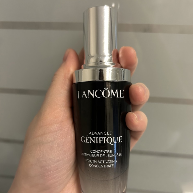 Close-up of Lancôme Genifique Ultimate Serum on a windowsill.