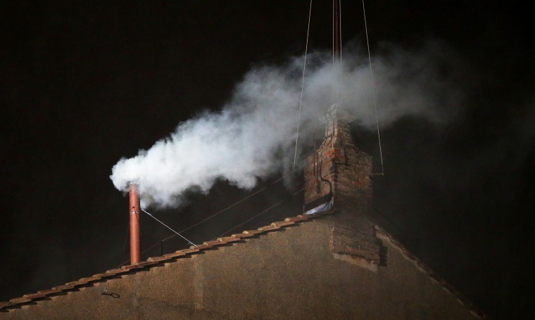 White smoke billows from the chimney on the roof of the Sistine Chapel indicating that the College of Cardinals have elected a new Pope in 2013.
