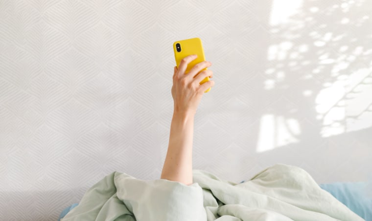 good morning, sunny day woman checking phone