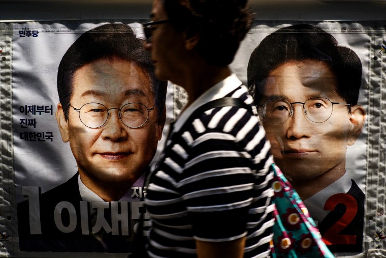 a banner showing Lee Jae-myung and Kim Moon-soo