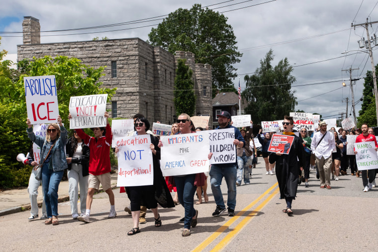 Protesters hold signs as they march