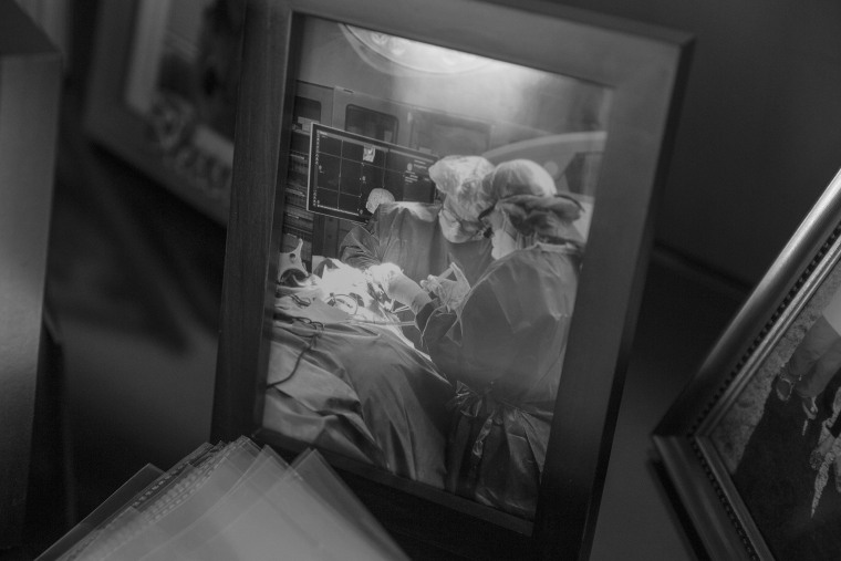 Framed photo of Dr. Mazzola performing a surgery.