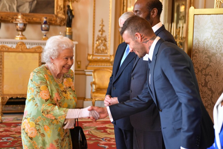 Queen Elizabeth II meets David Beckham at Buckingham Palace on June 26, 2018 in London, England. 