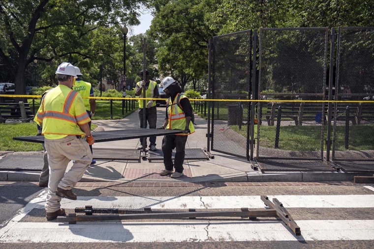 Workers put up fencing around Dupont Circle ahead of the World Pride Parade, Friday, June 6, 2025, in Washington, D.C.