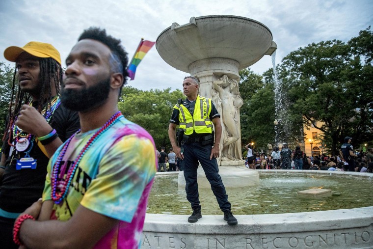A police officer watches the crowd at the conclusion of the Capitol Pride Parade at Dupont Circle in Washington in 2019.