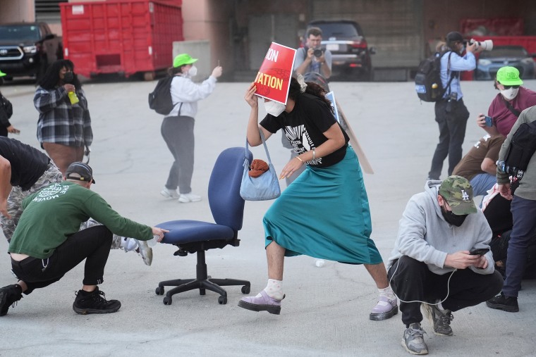 Crowd members react after law enforcement officers fired pepper balls during a protest