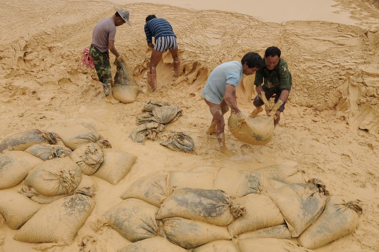 Labourers work at the site of a rare earth metals mine at Nancheng county, Jiangxi province