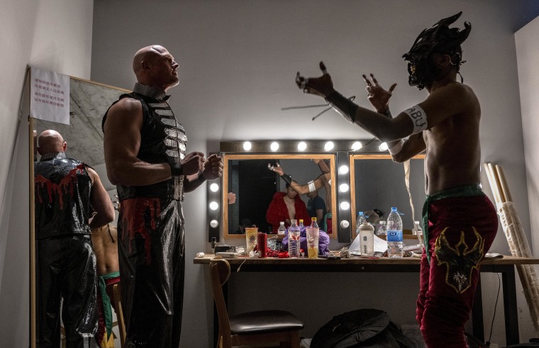 Wrestlers Chris Vice, left, and Zombie Dragon discussing moves before their match.