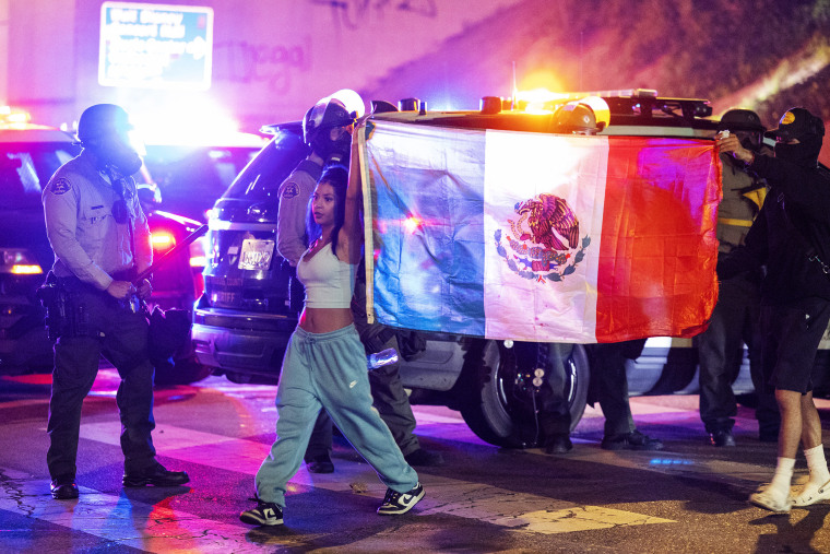 Demonstrators torched cars and scuffled with security forces in Los Angeles on June 8, as police kept protestors away from the National Guard troops President Donald Trump sent to the streets of the second biggest US city.