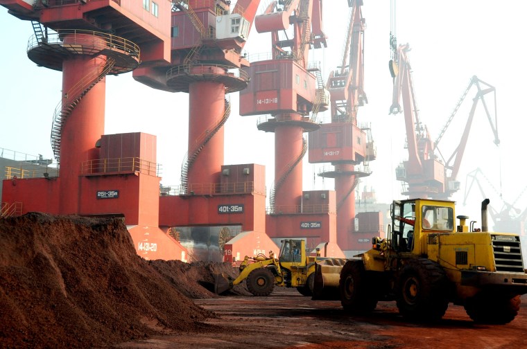 Workers transport soil containing rare earth elements for export at a port in Lianyungang