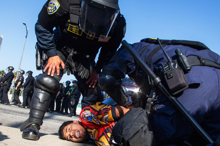 California Highway Patrol officers arrest a demonstrator