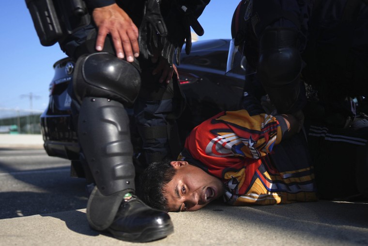 A protester is arrested by California Highway Patrol