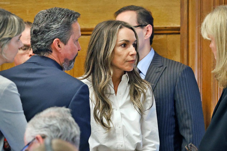 Karen Read talks with Norfolk County Superior Court Judge Beverly Cannone after she was asked whether she wants to take the stand in her own defense in Norfolk Superior Court in Dedham, Mass., on Wednesday.