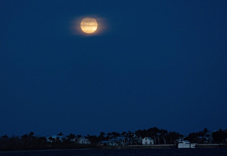 The full moon rises over Fort Myers Beach 