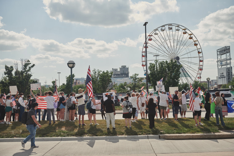 Demonstrators outside the College World Series in Omaha protest the recent immigration raids Friday.