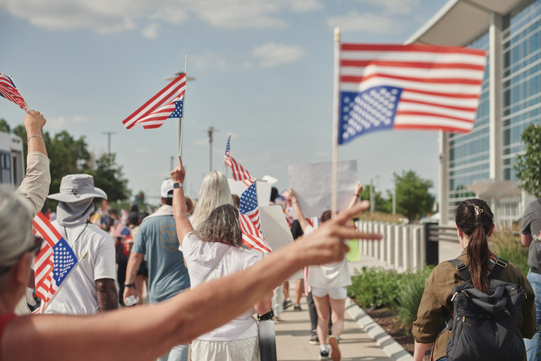 Demonstrators in Omaha wore white Friday to make a point that their protest was peaceful.
