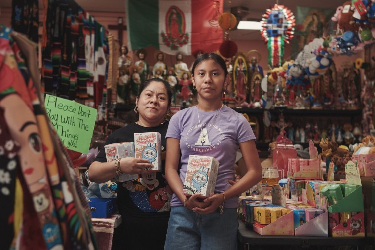 Business owner Samantha Santiago, pictured with her daughter Nicole, plans to donate some of the proceeds from the sale of the popular Labubu dolls to help families affected by Tuesday's raid.