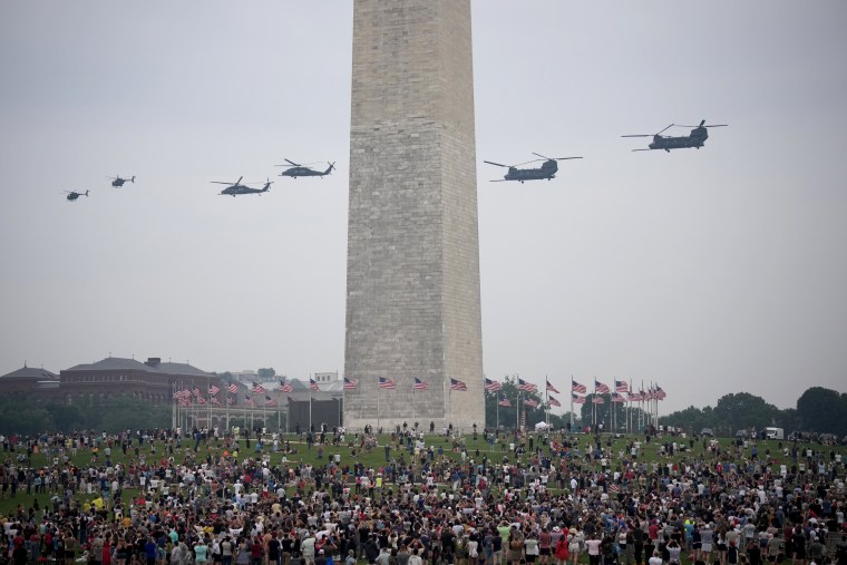 Image: Helicopers fly past the Washington Monument