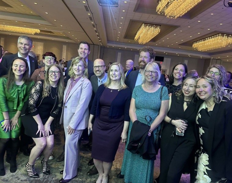 Melissa Hortman smiling while surrounded by colleagues