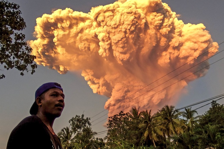 A villager watches the eruption of Mount Lewotobi Laki-Laki