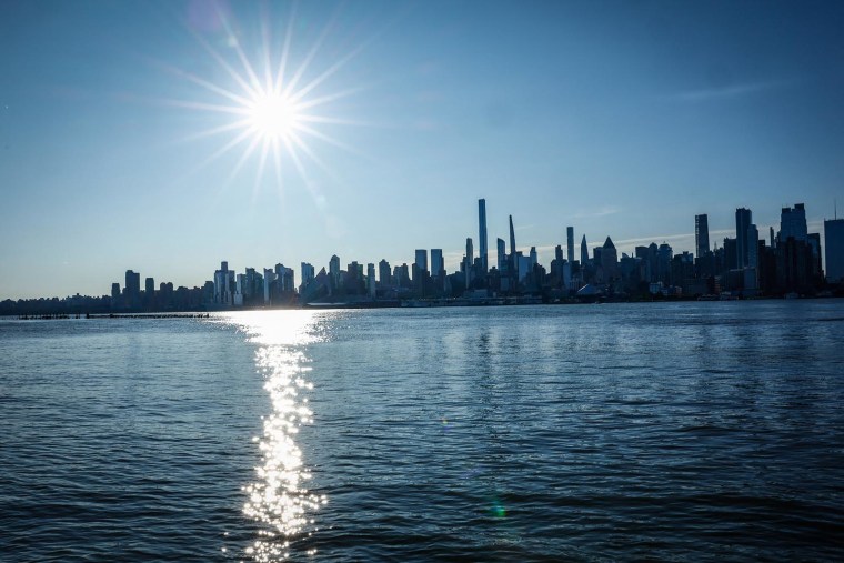 The sun rises over the New York skyline as seen from Weehawken N.J., on June 20, 2025.