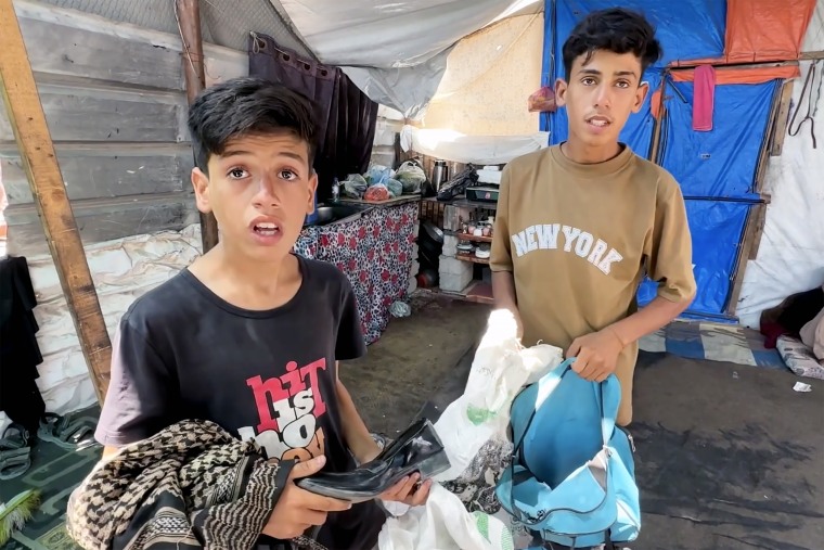 Reem Zeidan's son Ahmad, left, holding her belongings.
