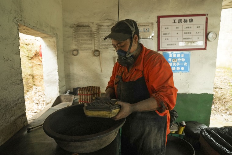 Workers at the factory wear color-coded uniforms from yellow to orange — orange being the most dangerous — to indicate the level of danger linked with their tasks.