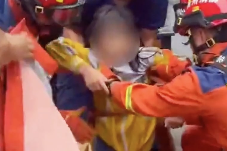 A girl in China is rescued from a storm drain after intense flash flooding.