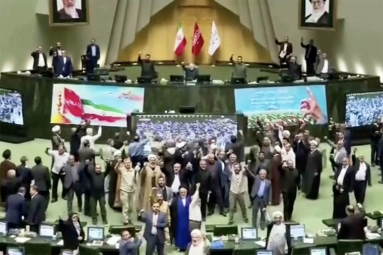 Lawmakers chanting during Iranian parliament open session in Tehran on Wednesday.
