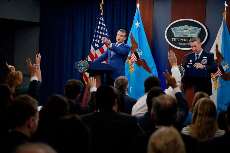 Defense Secretary Pete Hegseth, accompanied by Chairman of the Joint Chiefs of Staff Air Force Gen. Dan Caine takes a question from a reporter during a news conference at the Pentagon