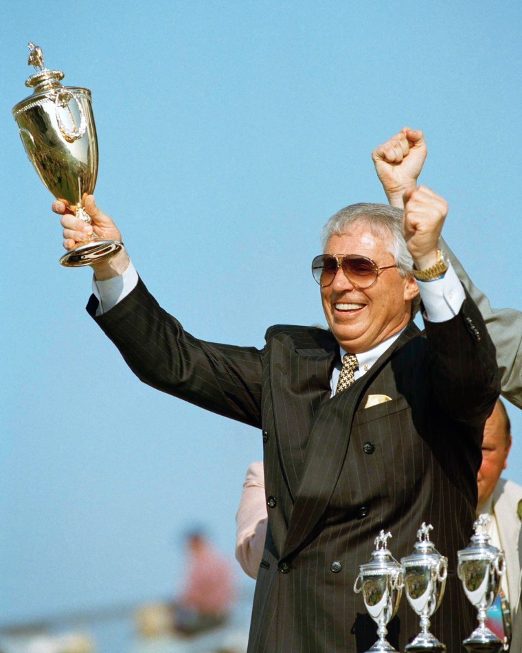 Trainer D. Wayne Lukas celebrates in the winners circle after his horse Thunder Gulch, ridden by Gary Stevens, won the 121st running of the Kentucky Derby, at Churchill Downs in 1995.