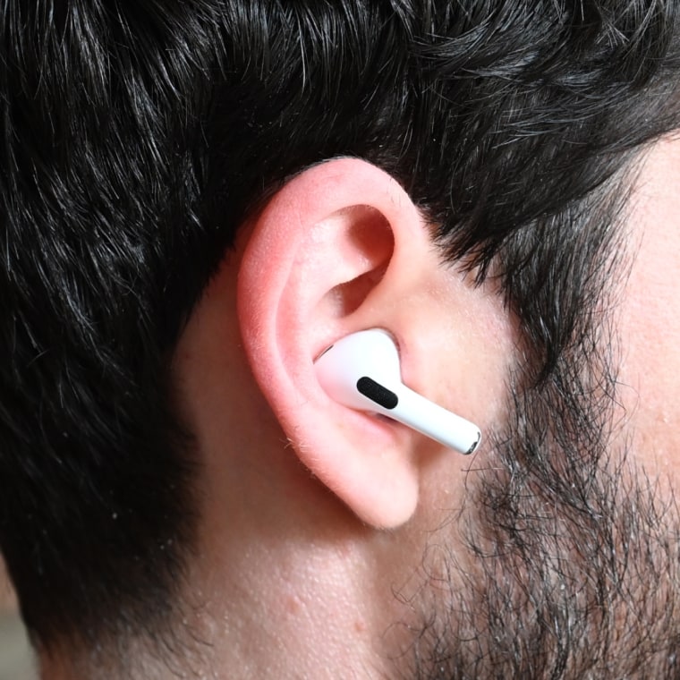 A close up of an Apple AirPods Pro 2 earbud in the ear of the writer.