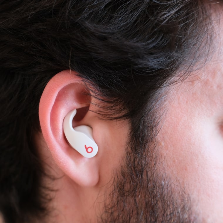 A close up of a Beats Fit Pro earbud in the ear of the writer.