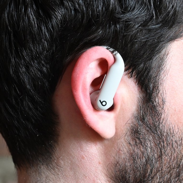 A close up of a Beats Powerbeats Pro 2 earbud in the ear of the writer.