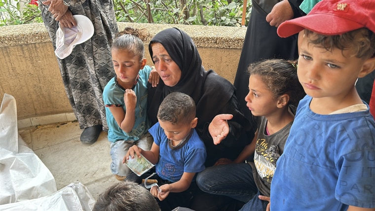 Reda Abdel Rahim Eljara mourns over her sons who were killed by an Israeli strike on the first day of Eid al-Adha.