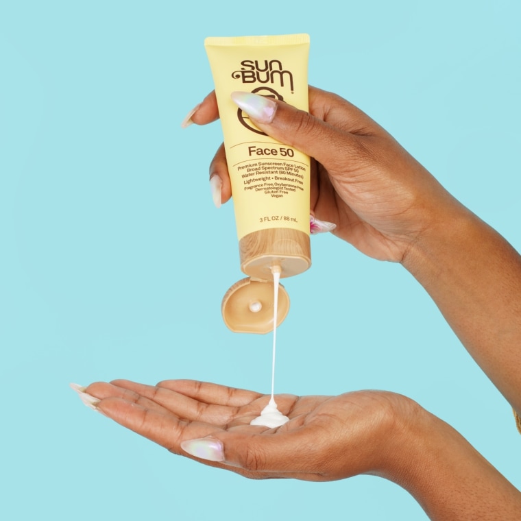Woman squeezing drop of Sum Bum’s Daily Face Liquid Lotion Sunscreen onto hand