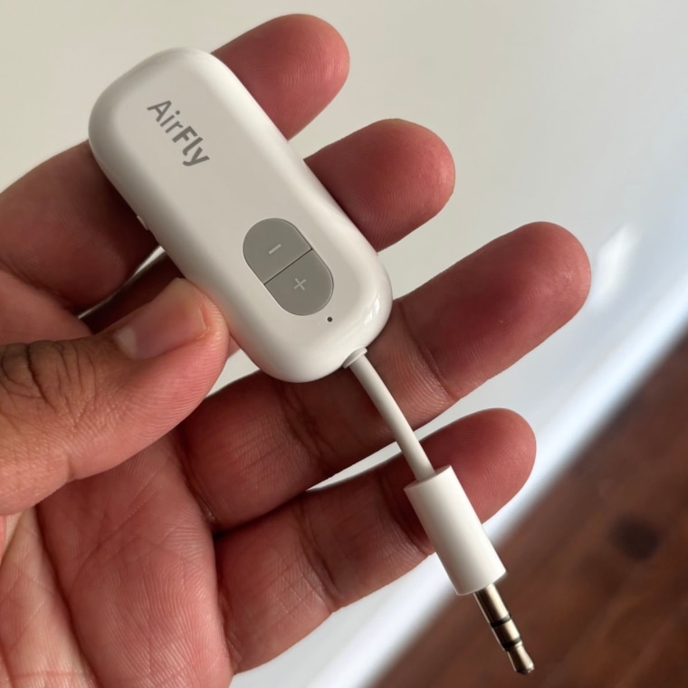 Person holding the Twelve South AirFly SE Bluetooth Audio Adapter with left hand.
