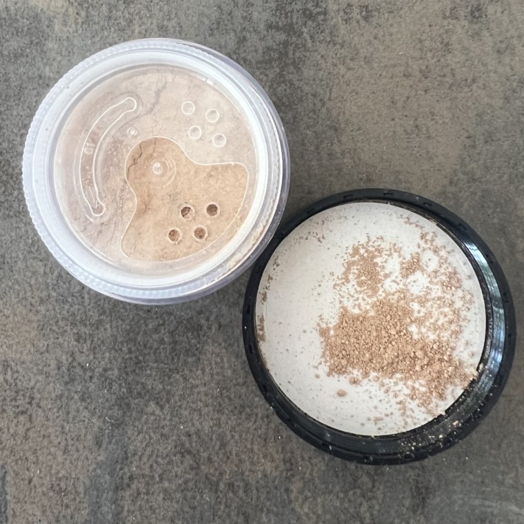 Powder foundation container and lid on table