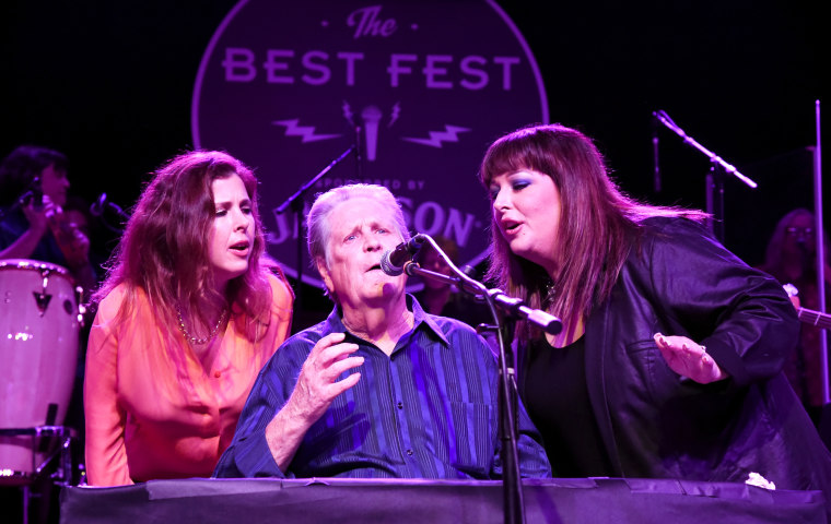 Wendy Wilson, Brian Wilson and Carnie Wilson onstage.